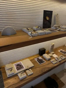 Display shelves showcasing elegant silver and gold handmade jewelry pieces, part of the creations from the best silver class experience in Bali.