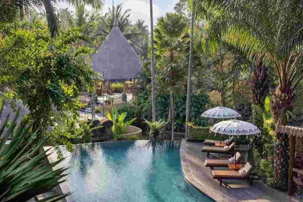 Cozy swimming pool area with sun loungers at Sankara Resort – Best Resort in Ubud.