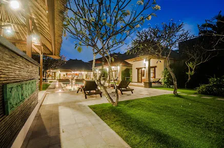 Luxury villa in Seminyak with tropical garden and night ambience, available with special offers through Voucher Villas Seminyak.