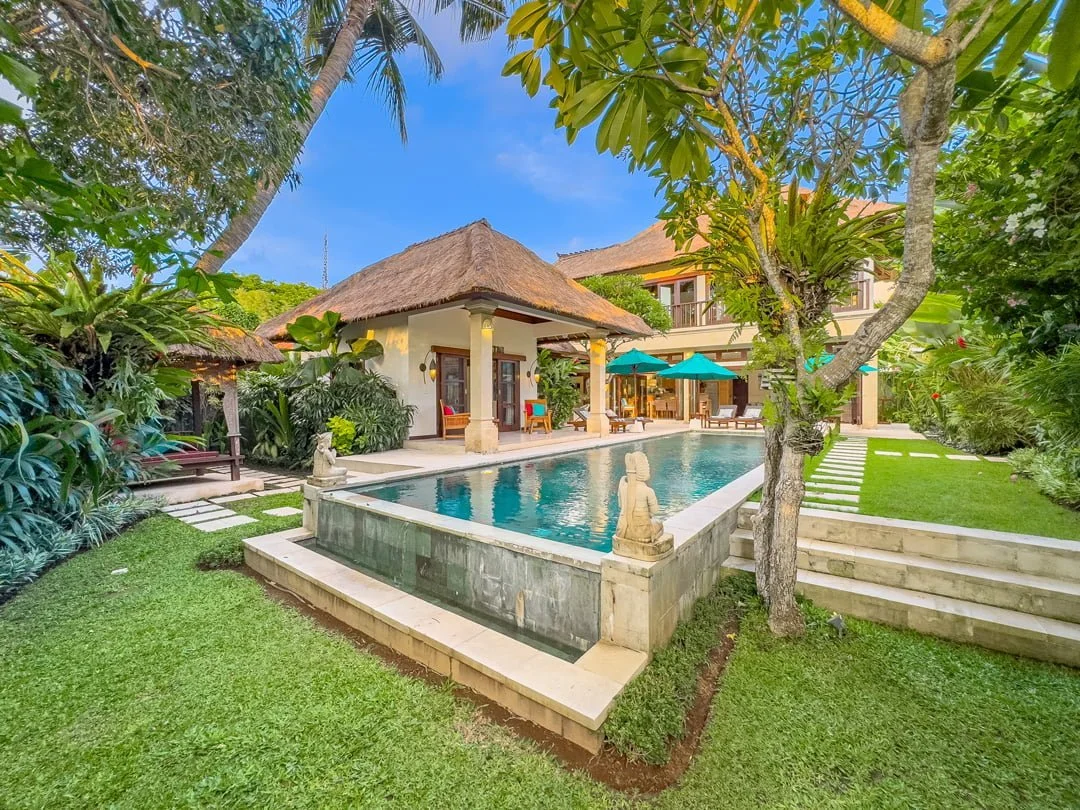 Tropical garden and elegant poolside area at Luxury Villas Seminyak, featuring traditional Balinese architecture and serene ambiance.